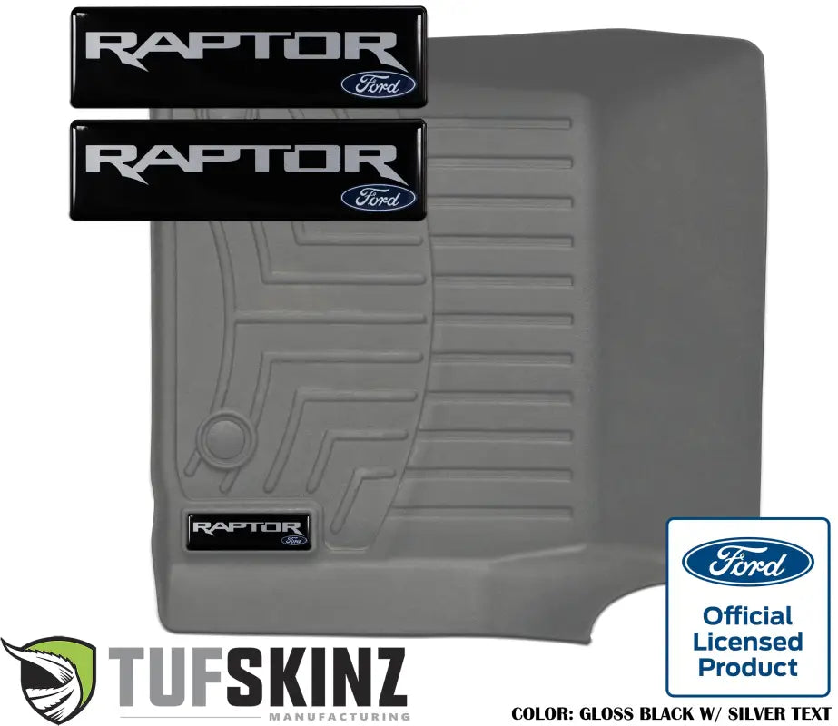Gloss black badge inserts with silver 'Raptor' text designed to fit WeatherTech floor mats, featuring Ford official licensed product branding.