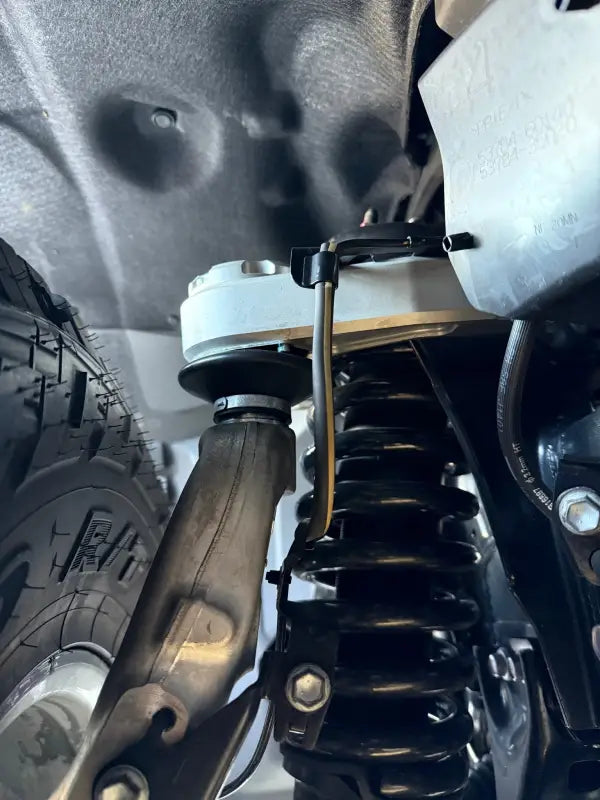 Kevlar reinforced, completely sealed precision machined vehicle suspension system for Tacoma and Landcruiser
