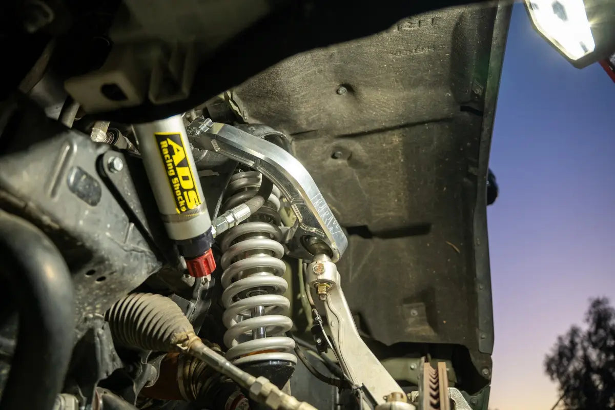 Silver suspension system with yellow shock absorber for Colorado ZR2, kevlar reinforced and precision machined