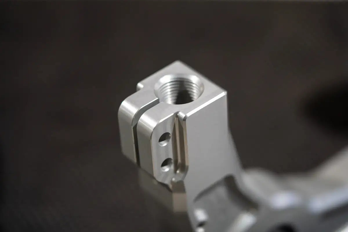 Machined metal component with threaded hole for Silverado 1500 Billet Uniball UCA, kevlar reinforced