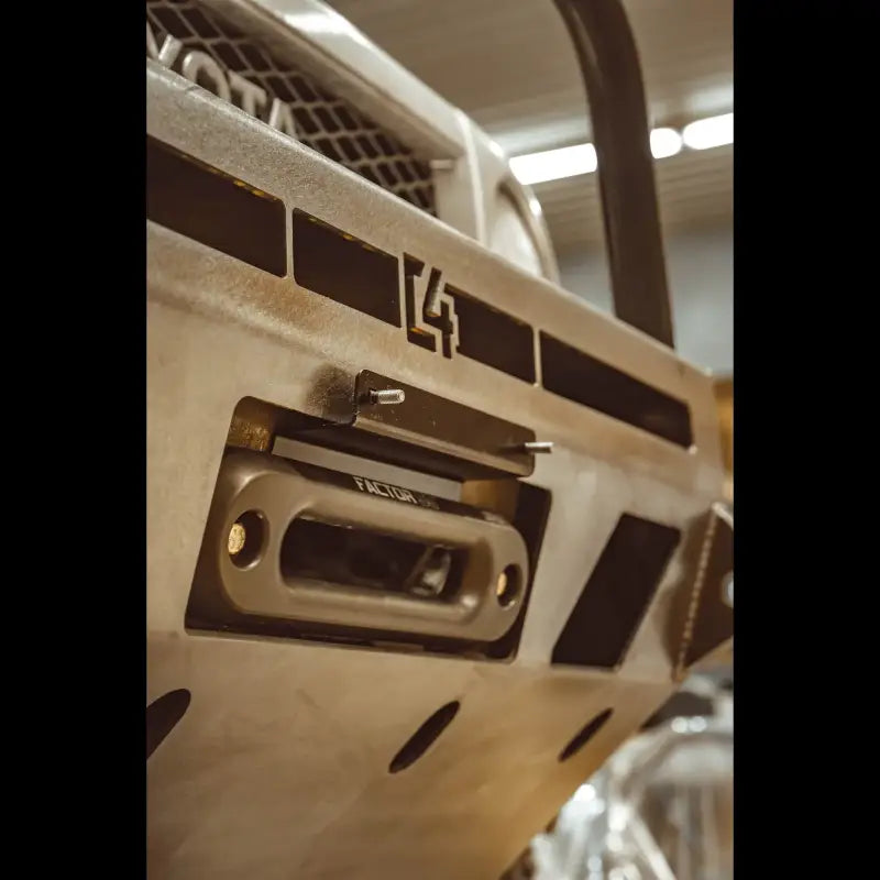 Close-up of the C4 Hawse License Plate Mount attached to a bumper with a hawse fairlead, highlighting its rugged construction and removable design.