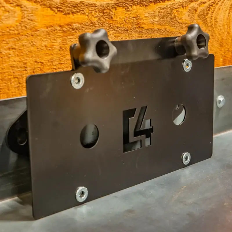 C4 Hawse License Plate Mount made of 14ga steel with a sleek black finish, featuring a C4 logo cutout and adjustable knobs for easy installation.