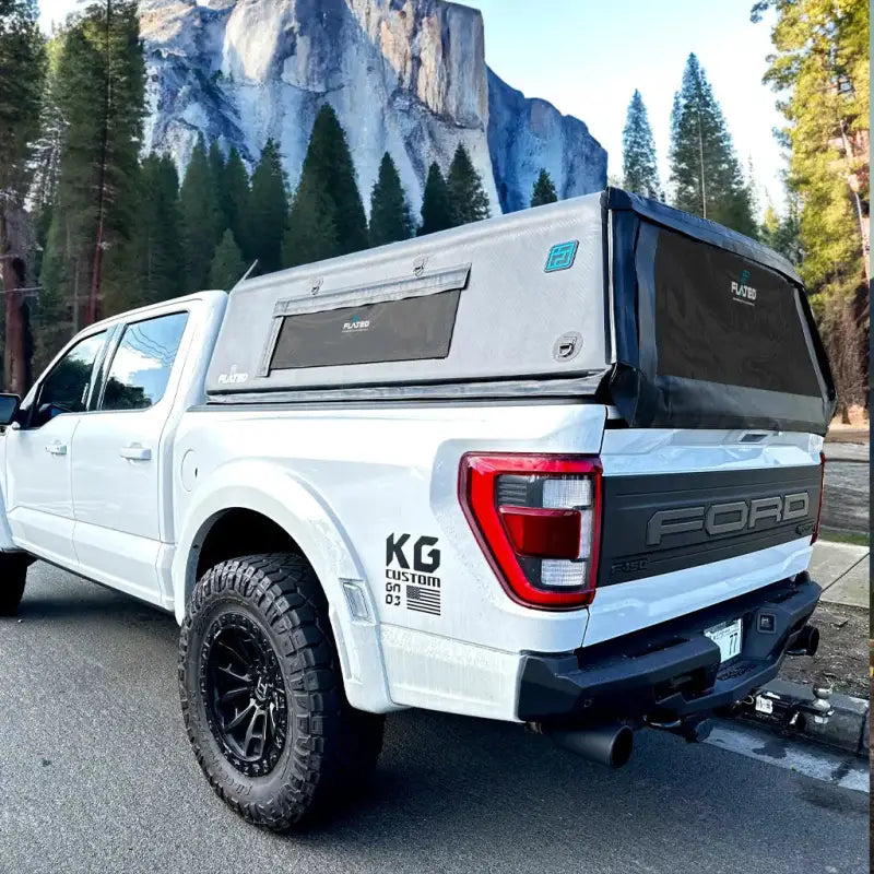 5.5' Bed Air-Topper CAP installed on a white truck in a scenic outdoor setting, ideal for camping and versatile truck use.