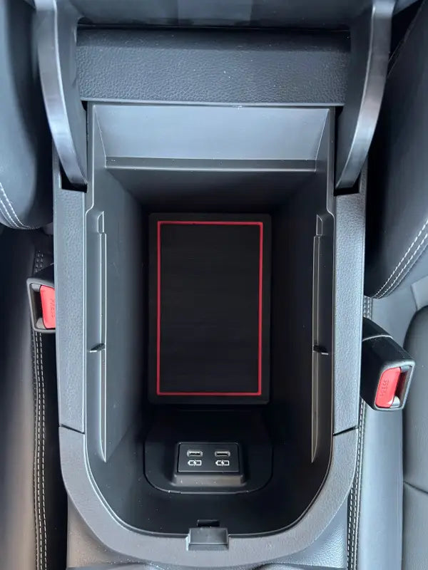 Close-up of a center console foam insert with red trim fitted in a 2019-2024 Toyota Rav4, designed for improved storage and decor.