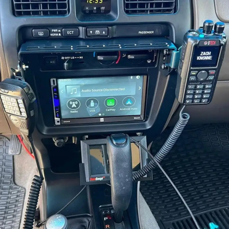 3rd Gen 4Runner console mount setup with multiple accessories, including a radio and phone holder, for enhanced functionality.