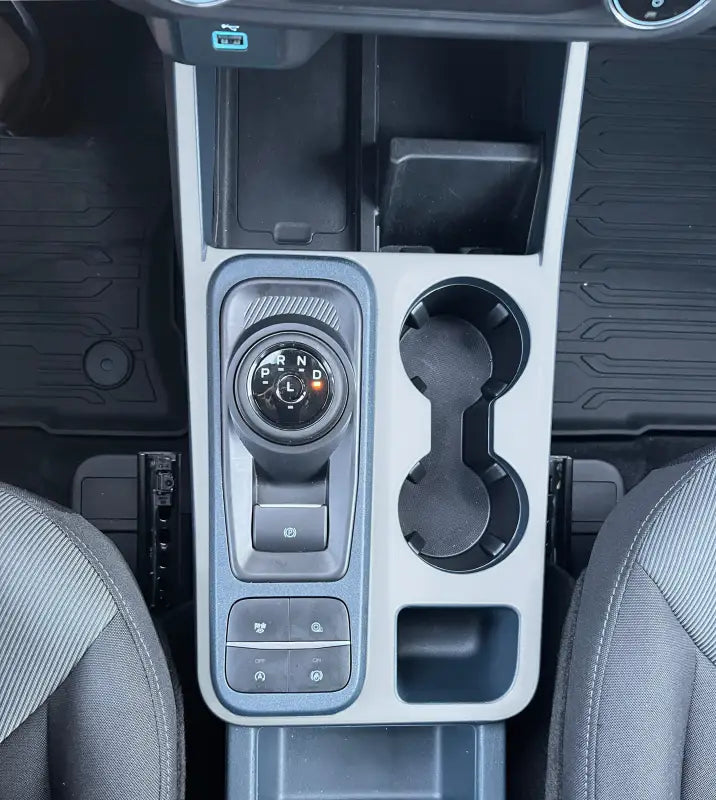 Center console surround accent overlay for 2022-2024 Ford Maverick showing gear selector and cupholders