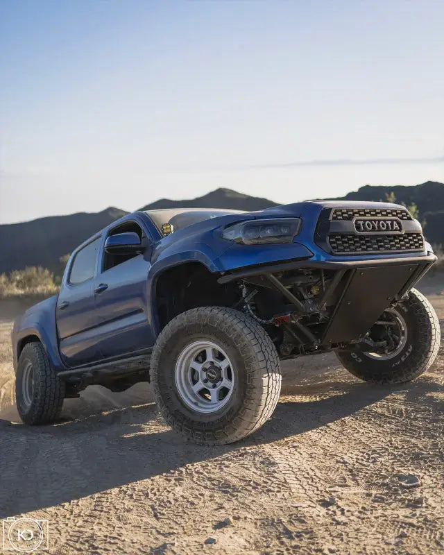 Blue Toyota Tacoma off-road truck with Custom Pre Runner Bumper and upgraded lower radiator support