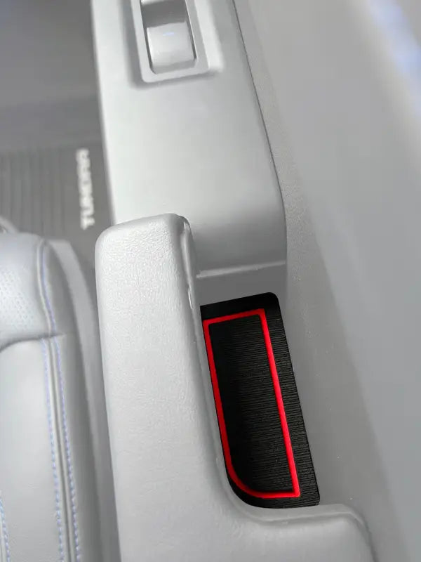 Close-up view of a red-outlined door handle foam insert installed in a 2022-2024 Toyota Tundra interior, enhancing decor and protection.