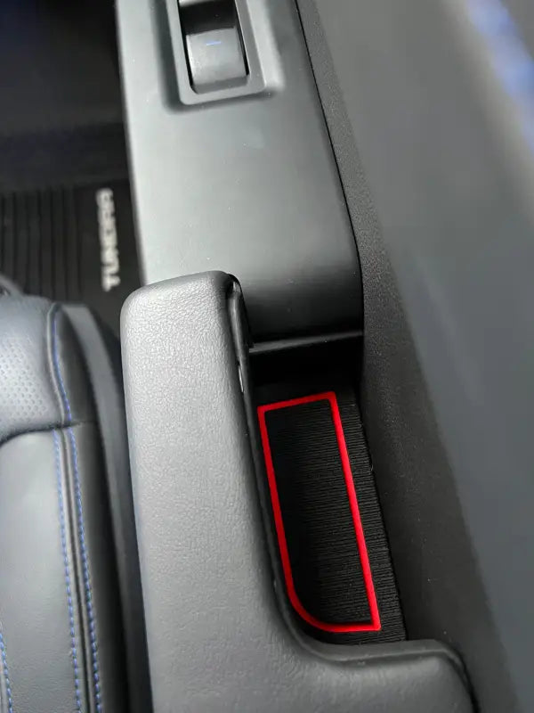 Red-accented foam insert fitted into the door handle of a 2022-2024 Toyota Tundra, showcasing a sleek and functional interior accessory.