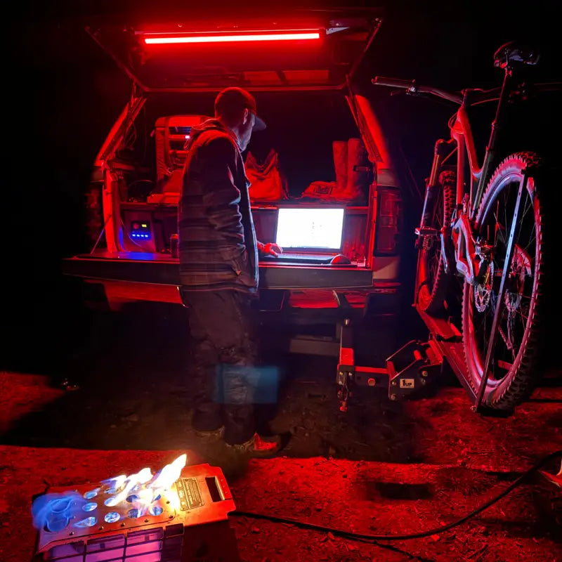 Red-lit truck bed setup with F-Series 12in Light and add 360-degree rotation feature