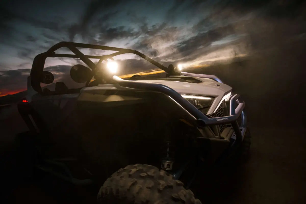 FLEX ERA® 3 LED light pod mounted on a vehicle hood, with amber accents and KC logo, ideal for off-road lighting.