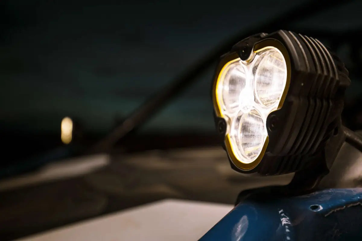 FLEX ERA® 3 LED light pod mounted on a vehicle, emitting bright white light for enhanced off-road visibility at night.
