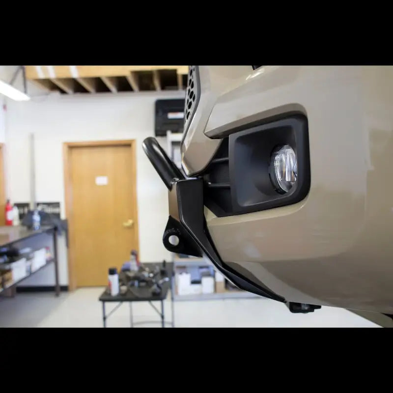 Close-up of the Lo-Pro winch bumper on a Toyota Tacoma, showing welded D-ring tabs and precise fitment for 2016+ models.