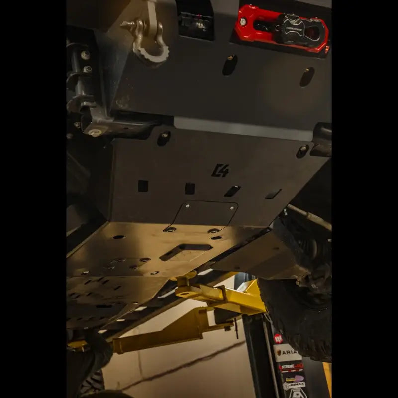Close-up of a mounted Tacoma front skid plate with durable CNC steel protection, designed for 2005+ Toyota models, featuring oil change access.