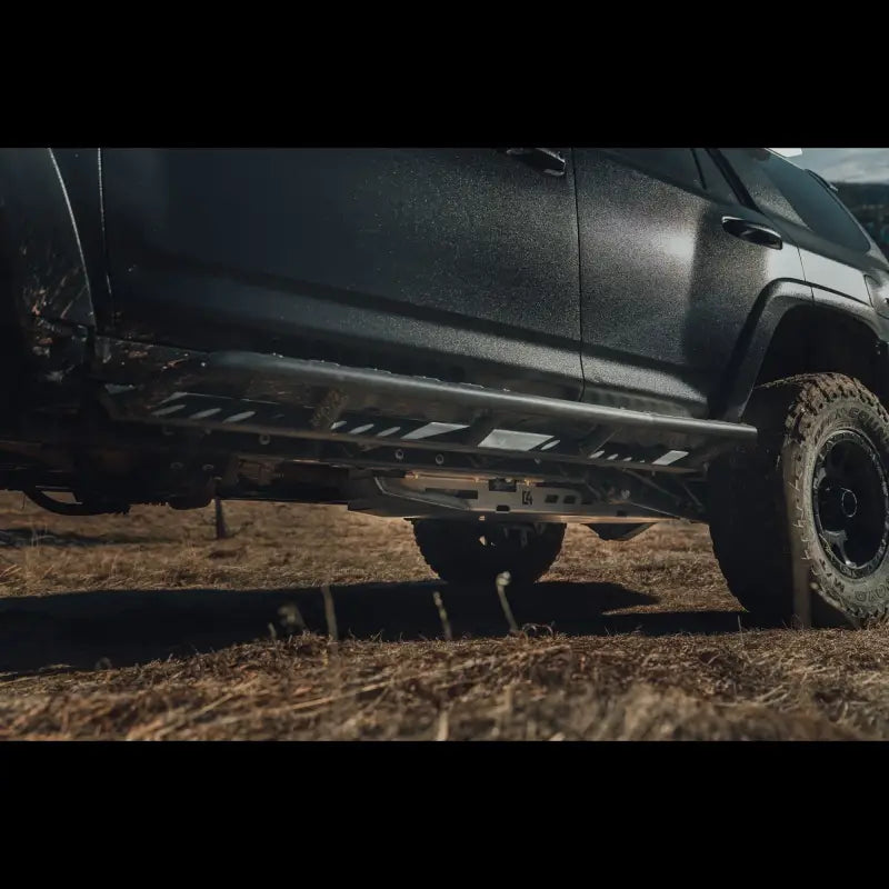 Side view of a 5th Gen 4Runner with a bolt-on steel skid plate installed, providing undercarriage protection for off-road use.