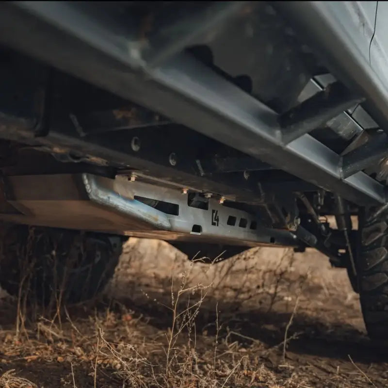 4Runner skid plate installed under a 5th Gen 2010+ vehicle, showcasing durable steel construction with drainage cutouts for fuel tank protection.
