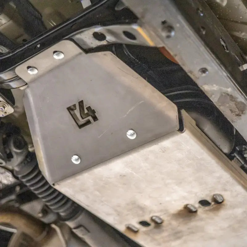 Tacoma skid plate installed under a vehicle, protecting the fuel tank with durable steel construction for 2005-2015 models.