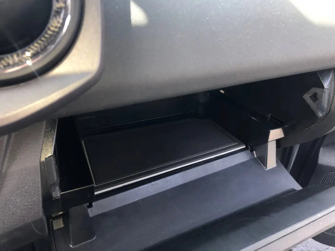 Close-up of glove box foam insert fitted in a 2016-2023 Toyota Tacoma, showcasing precise fit and durable material.