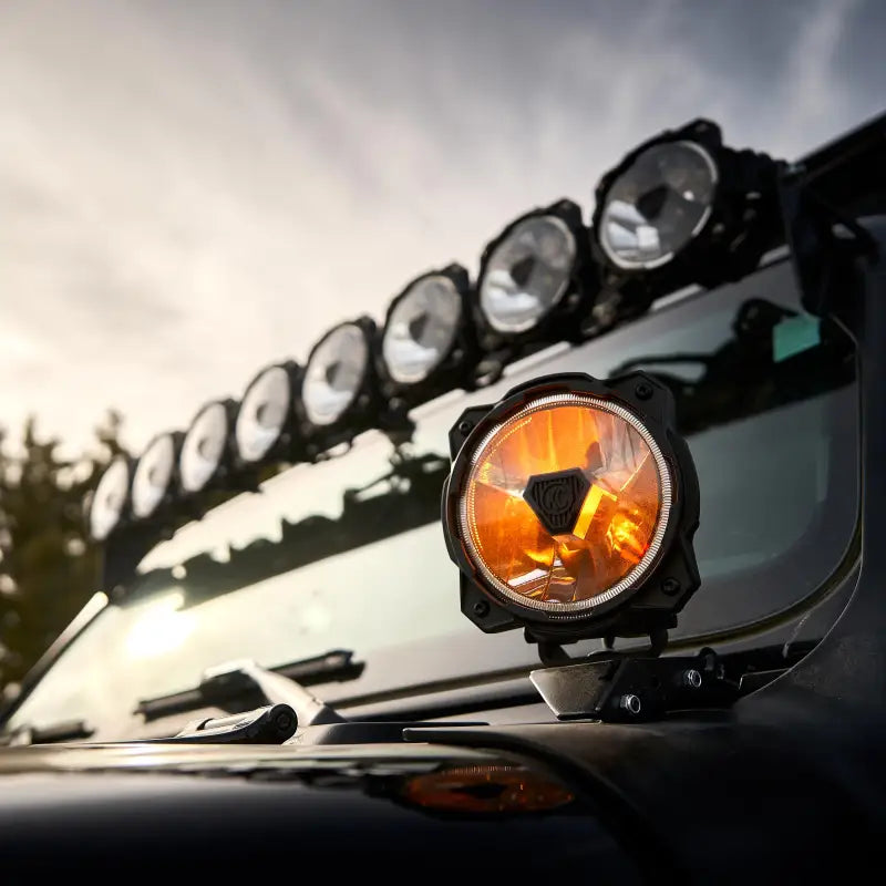 Gravity Titan 6" LED Light in amber mode mounted on a vehicle, perfect for off-road visibility.