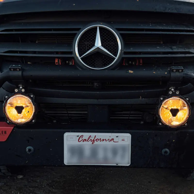 Front view of Mercedes Sprinter van with Gravity® Titan™ 6" LED lights, emitting a warm driving beam for enhanced visibility.