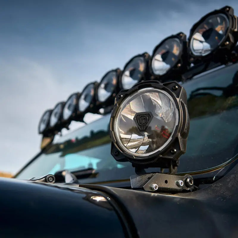 Gravity® Titan™ 6-inch LED off-road light mounted on a vehicle, showcasing its powerful illumination and rugged design.