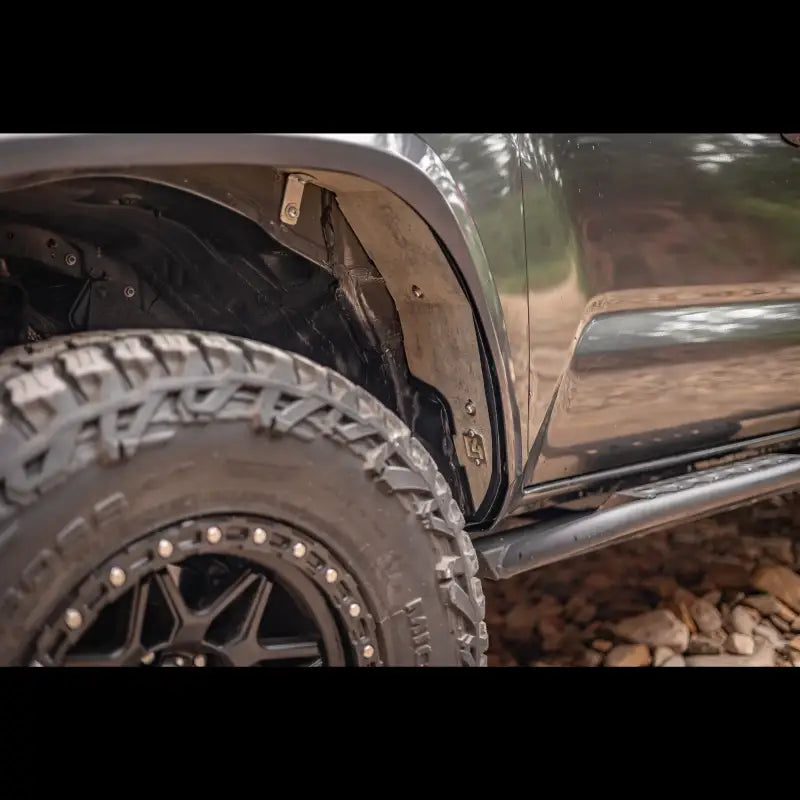 Close-up of high clearance aluminum fender liner on a 3rd Gen Tacoma, designed for enhanced tire clearance and durability.