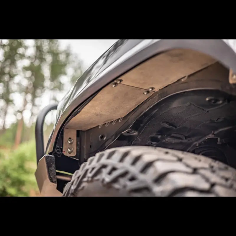 Underside view of bolt-in aluminum fender liner on a 3rd Gen Tacoma, highlighting rugged construction and precise fitment.