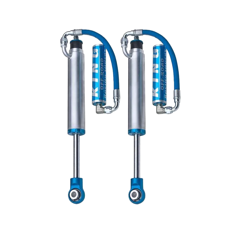 Pair of King 2.5 rear shocks with external reservoirs, engineered for mid travel suspension on Toyota Tacoma models from 2005 to 2023.