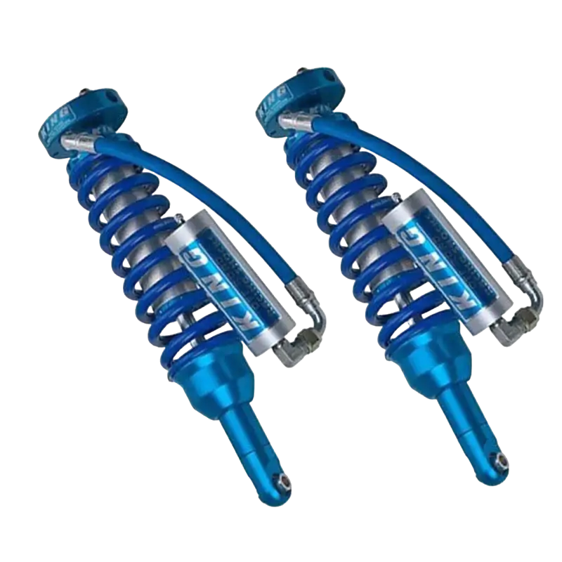 King 2.5 front coilovers with external reservoirs, part of the mid travel suspension kit for Toyota Tacoma (05-23), offering adjustable compression.