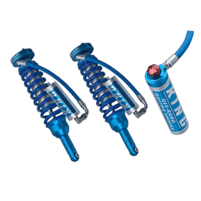 Close-up of King 2.5 front coilovers with external reservoirs, designed for mid travel suspension on Toyota Tacoma models from 2005 to 2023.