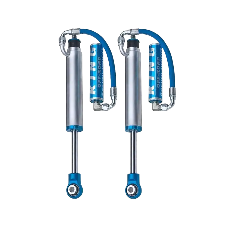 Pair of King 2.5 rear shocks with external reservoirs, engineered for mid travel suspension on Toyota Tacoma models from 2005 to 2023.