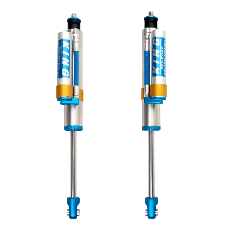 19-23 Ram 1500 King 2.5 Performance Series rear shocks with anodized blue and gold accents, designed for improved ride quality and durability.