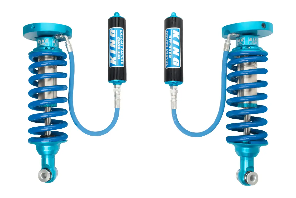 High-performance King 2.5 Coilover Kit for 18-23 Ford Expedition, showcasing blue springs and remote reservoirs for optimal suspension tuning.