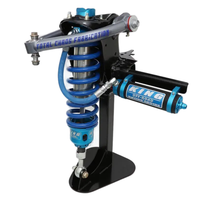 Toyota Tundra King 3.0 Stage 3 Coilovers installed on a suspension assembly, featuring blue springs and Total Chaos Fabrication components.