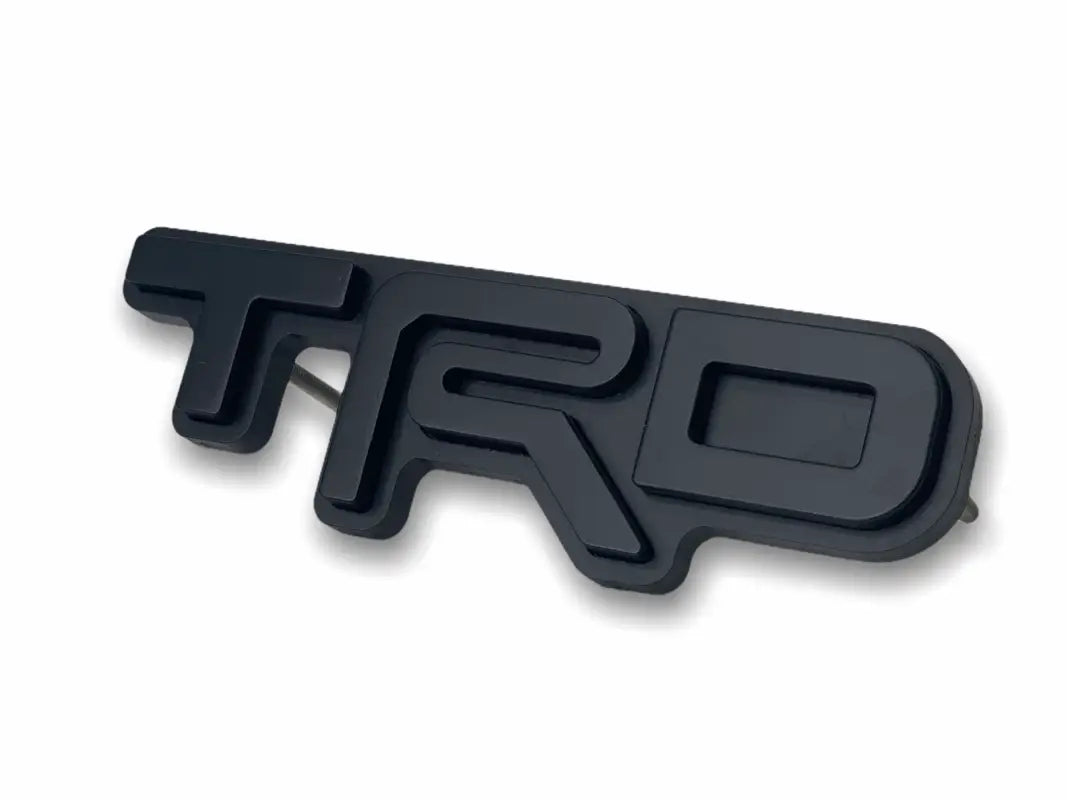 Black TRD emblem logo grille badge for route protection and stylish vehicle enhancement