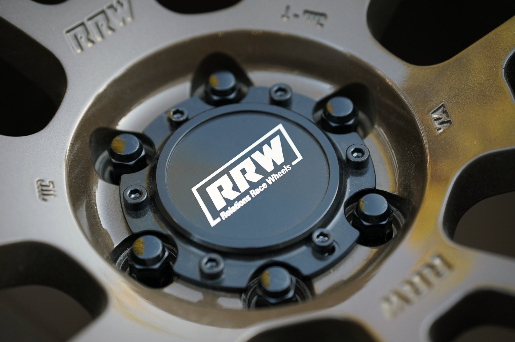 Close-up of RRW wheel center cap with black hex lug nuts installed, showcasing a secure and stylish fit for Toyota, Chevy, and Jeep vehicles.