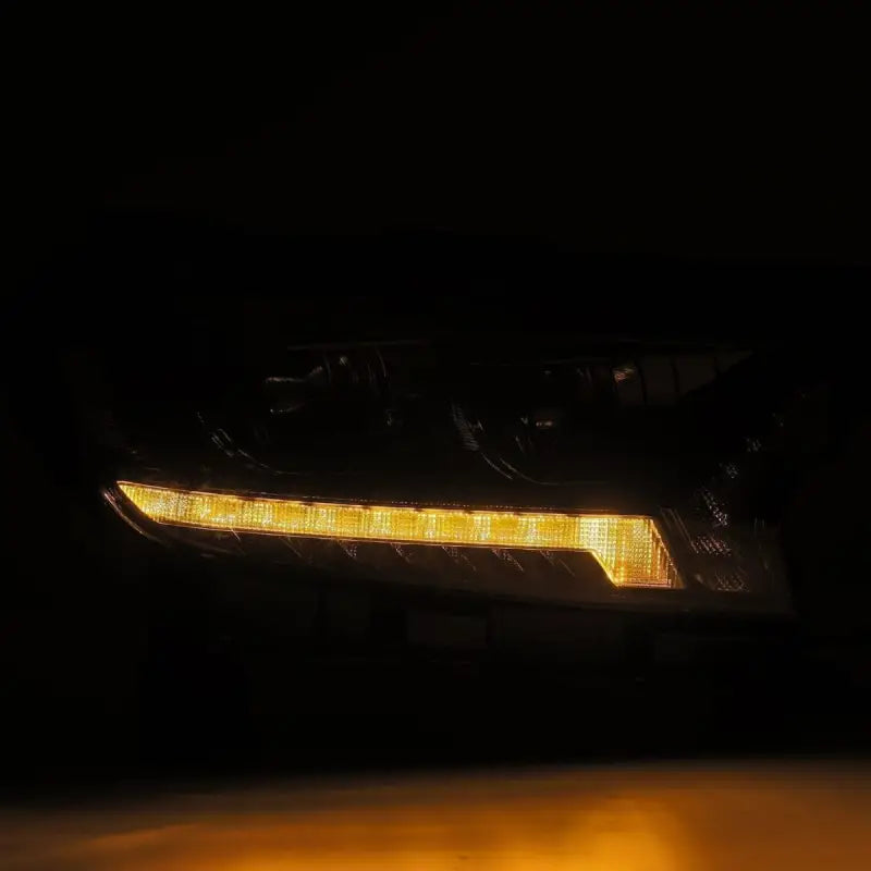 Ford Ranger 19-22 LUXX-Series LED projector headlight illuminated with amber sequential turn signal in a dark environment.