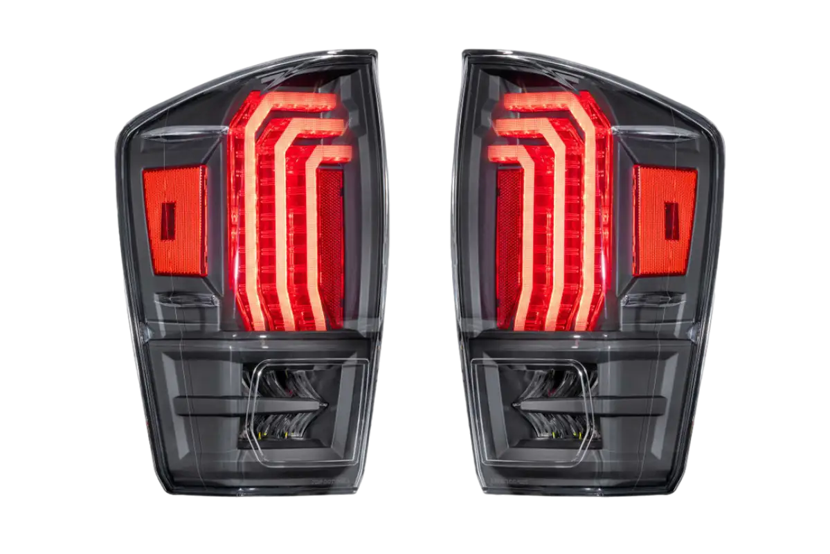 Morimoto Tail Lights for Tacoma (2016-2023) with clear lens, featuring modern LED design and red accents for enhanced visibility.
