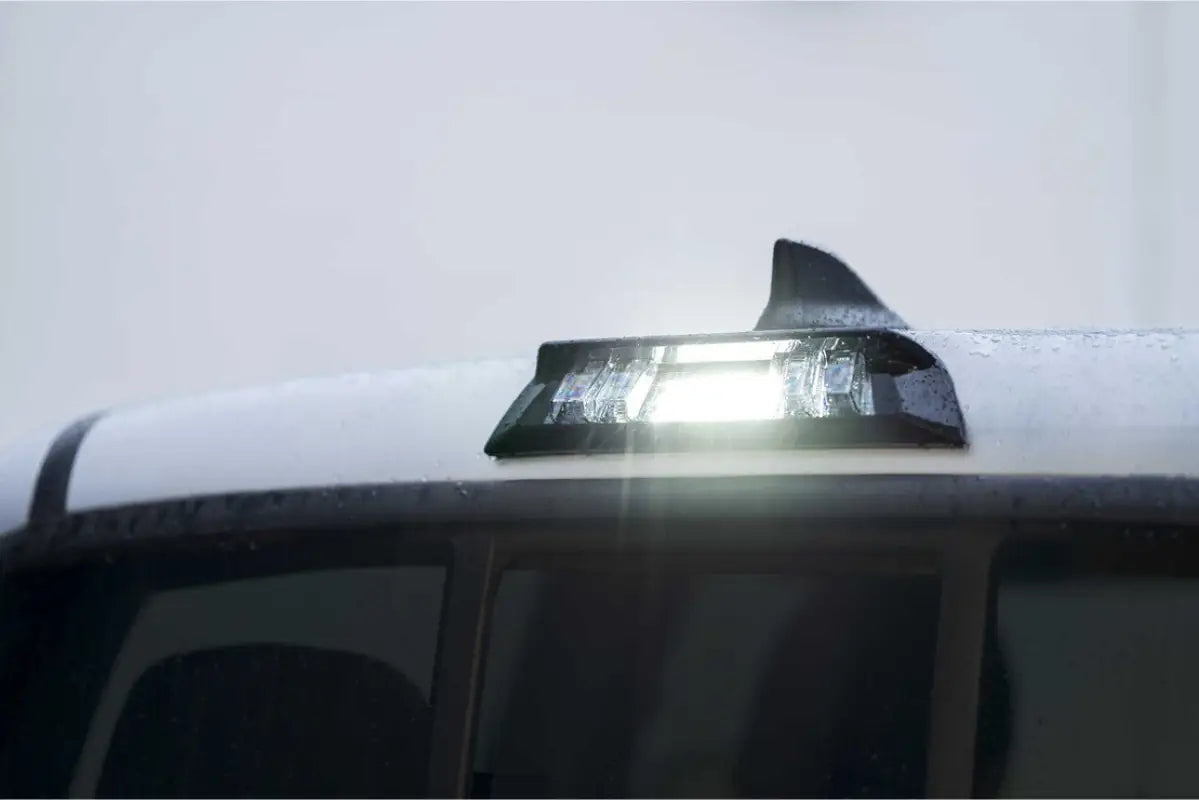 Morimoto X3B LED third brake light installed on a Tacoma (2016-2023) Double Cab, illuminated in white during daytime.