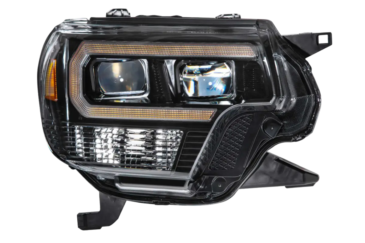 Morimoto XB LED Hybrid Headlight for Tacoma (2012-2015) showcasing dual projector lenses and amber LED accents.