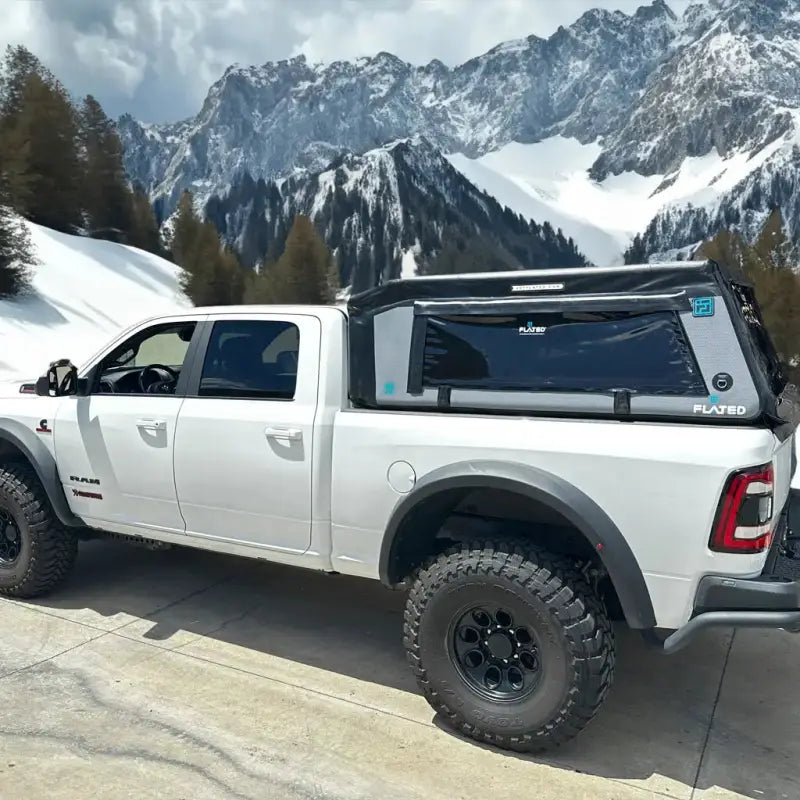 MR - Full-Size 6.4' Bed air-topper shell on a white truck in a snowy mountain setting, ideal for outdoor adventures.