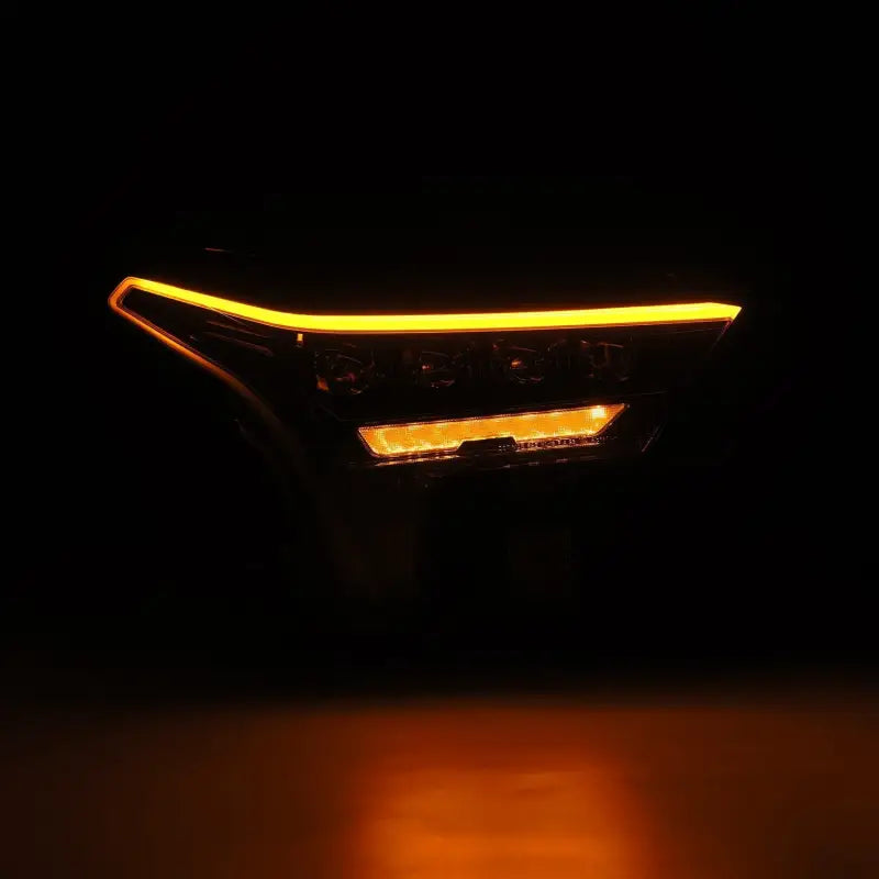 AlphaRex NOVA-Series LED projector headlight in Alpha-Black with amber DRL illumination, enhancing visibility and style.