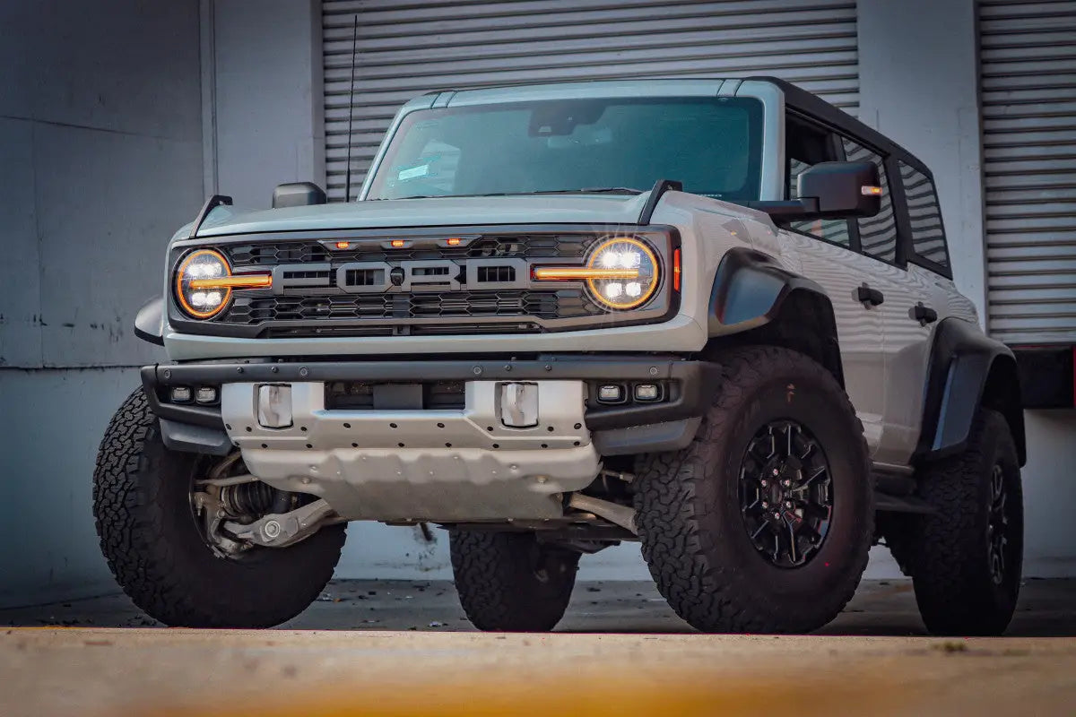 Ford Bronco with NOVA-Series LED projector headlights, parked in an urban setting, highlighting its rugged and stylish appearance.