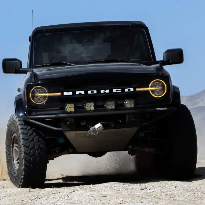 Front view of a Ford Bronco with NOVA-Series LED projector headlights, highlighting amber DRL and rugged off-road setup.