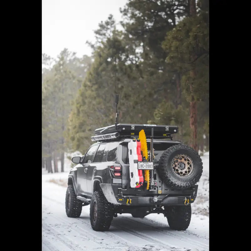 Gray SUV with roof rack and rear tire carrier showcasing Overland Series Rear Bumper
