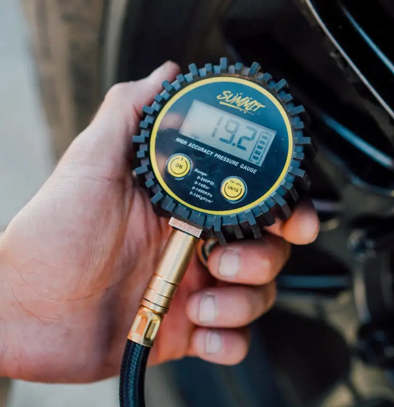 Close-up of Quick Air Down Tool's digital gauge displaying tire pressure in PSI, with easy-to-read LED screen and rugged design.