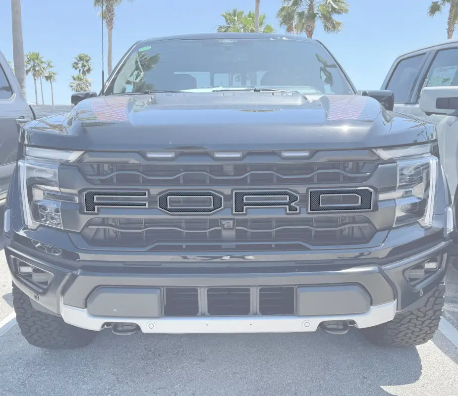 Black Ford truck front grill with Raptor grille letter overlays using automotive grade adhesive