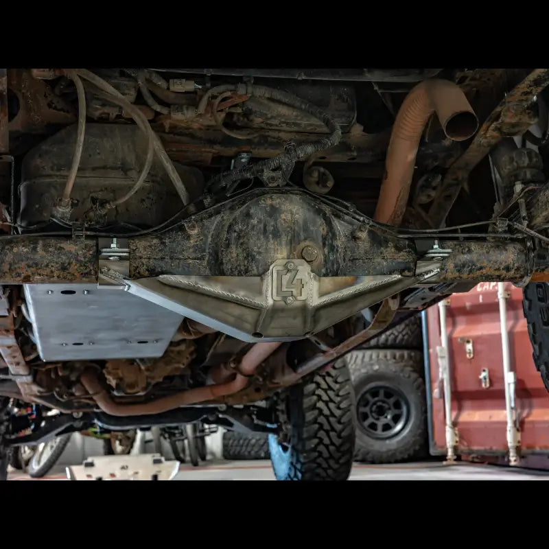 Underneath view of a Tacoma 2005-2015 with rear differential skid plate installed, protecting the driveshaft and u-joint.
