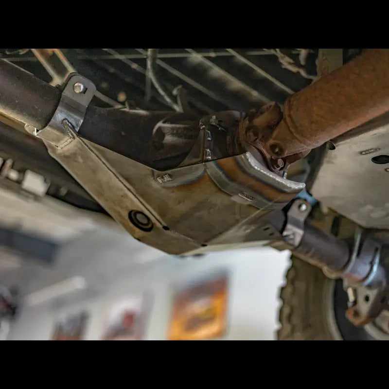 Close-up of Tacoma rear differential skid plate installed, highlighting E-locker guard and robust steel build.