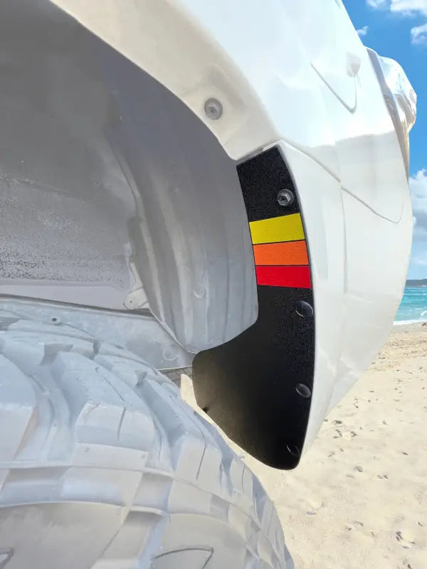 Rear mud flap delete kit installed on a 2010-2024 Toyota 4Runner, featuring a black finish with red, yellow, and orange stripes.